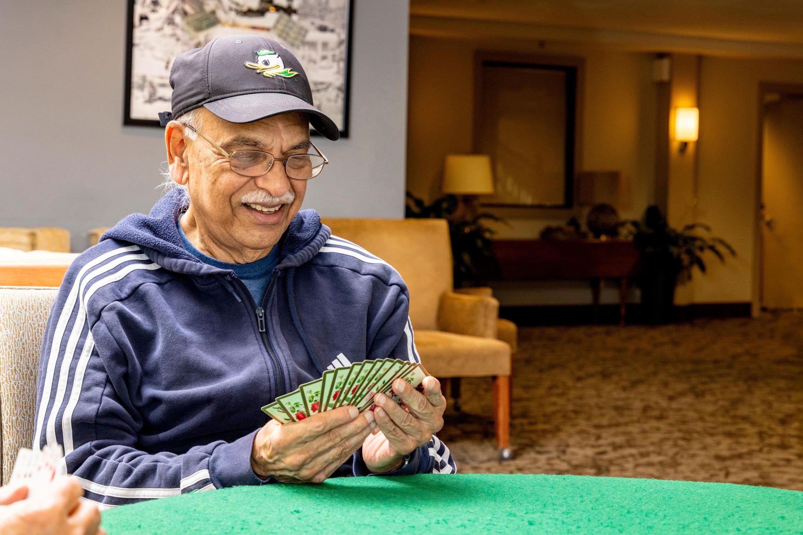A resident playing cards at Cascade Manor